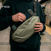 NIID N1L modular sling bag in Dewy Moss carrying a Nintendo Switch, showcasing the perfect portable storage solution for gamers, tech enthusiasts, and urban travelers on the go