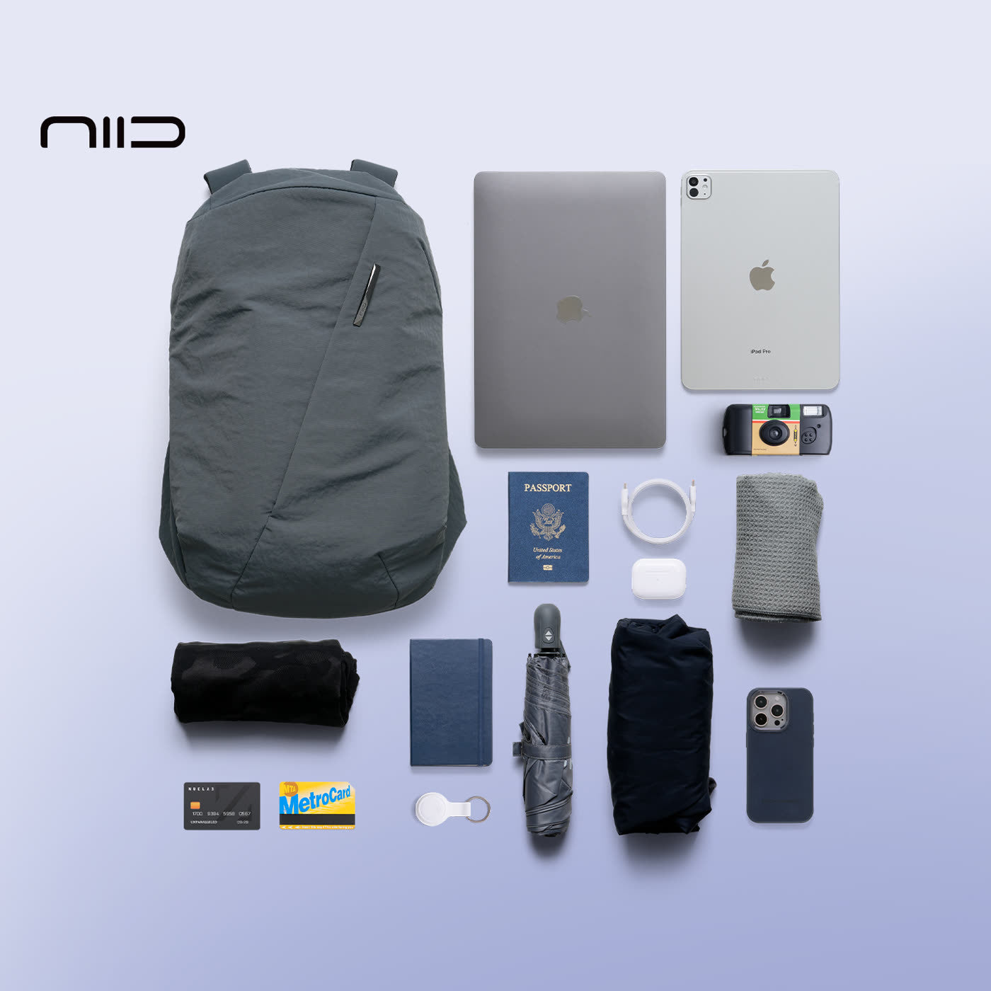 NIID N3 19L modular backpack in Mineral Grey displayed with full everyday carry essentials, including laptop, tablet, passport, and tech accessories, demonstrating optimized storage organization.