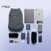 NIID N3 19L modular backpack in Mineral Grey displayed with full everyday carry essentials, including laptop, tablet, passport, and tech accessories, demonstrating optimized storage organization.