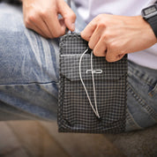 Close-up view of the NIID NEO Nomad Pouch in Graphene Gray, showcasing its compact design for easy travel and daily organization.
