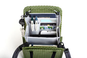 NIID NEO Nomad Pouch in Pine Green showing its full storage capacity, perfectly organizing travel essentials like a wallet, notebook, and power bank.