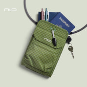 NIID NEO Nomad Pouch in Pine Green Ripstop, showing interior capacity for a passport, pens, and daily EDC essentials.