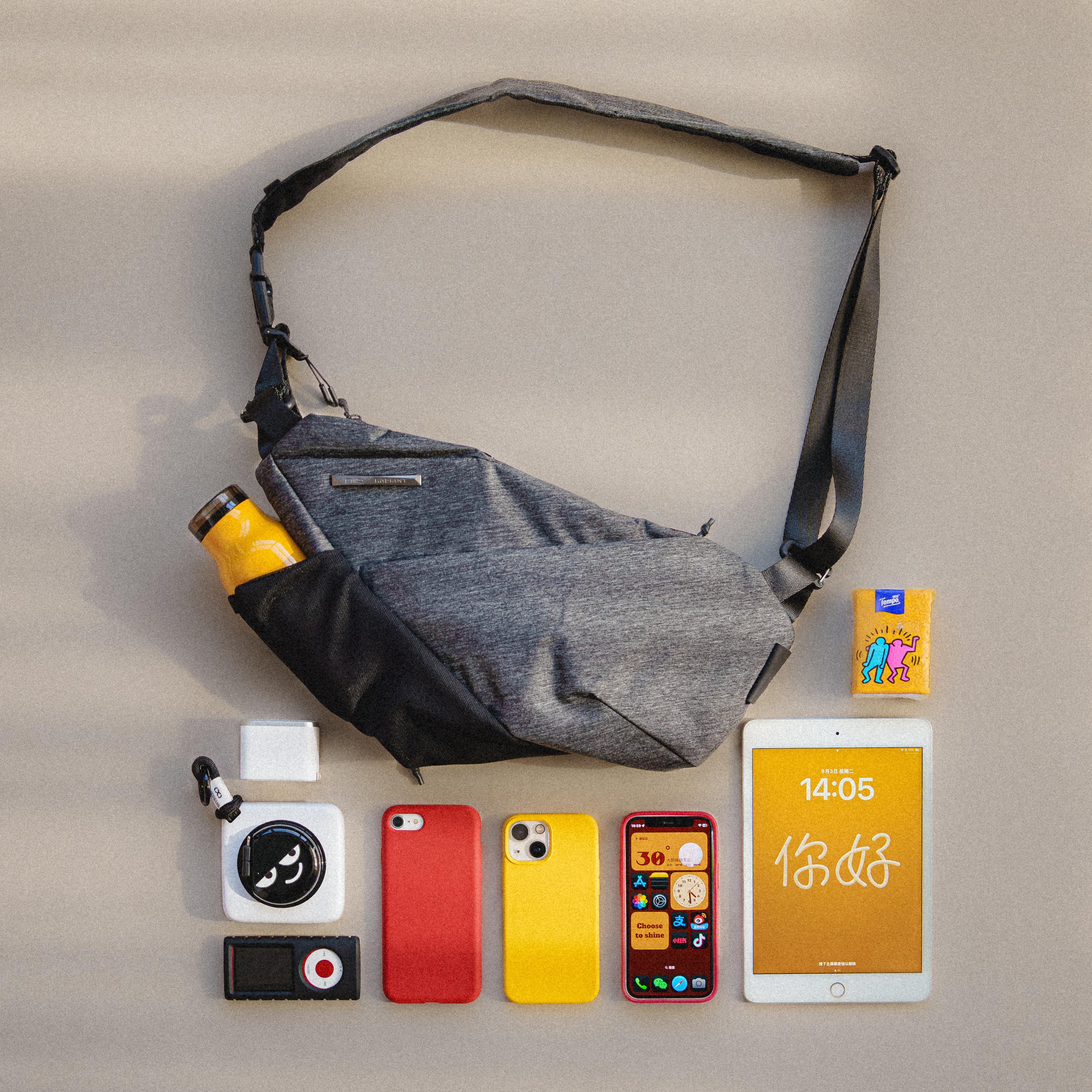 Flat‑lay top view of NIID FINO V Ultra‑slim Tech Sling Gray Shadow Grid arranged with smartphone, tablet, camera and daily travel tech accessories